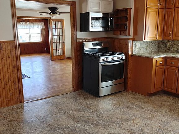 Kitchen with gas range and microwave