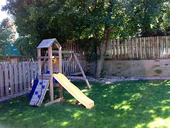 playset, fenced backyard