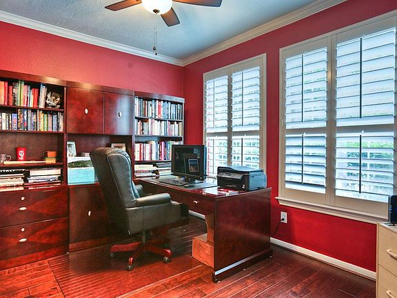 The study has crown molding, plantation style shutters, wood floors and French doors.