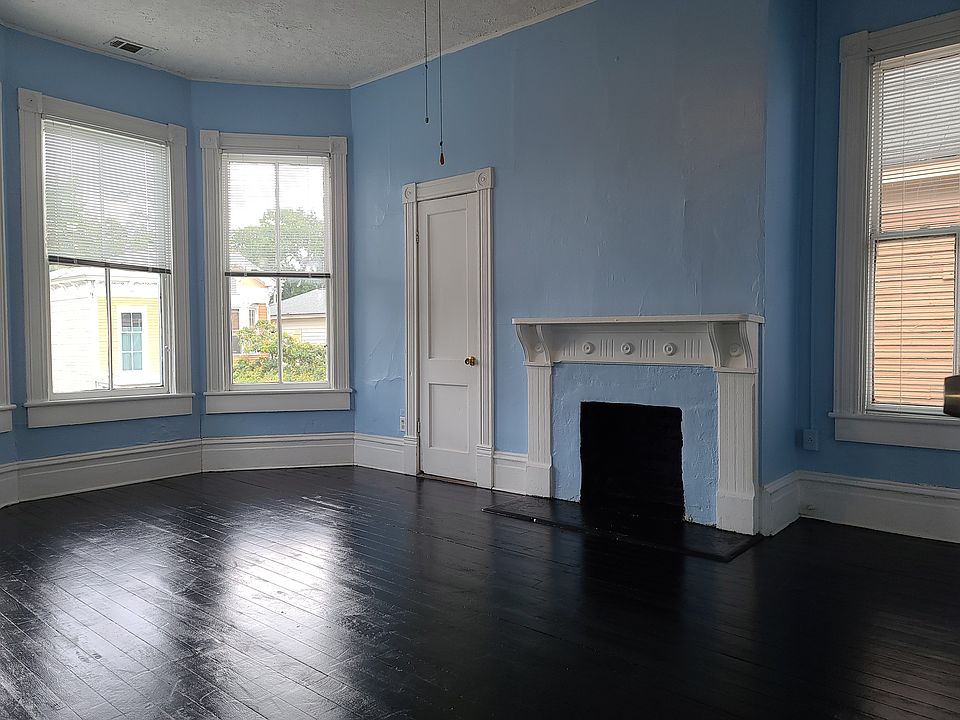 The sunny front room with closet, decorative fireplace and LOTS of windows!