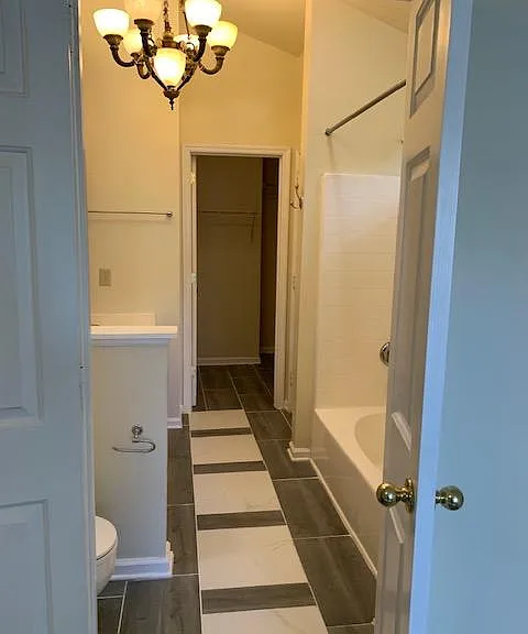 Owner's suite bath with closet at end