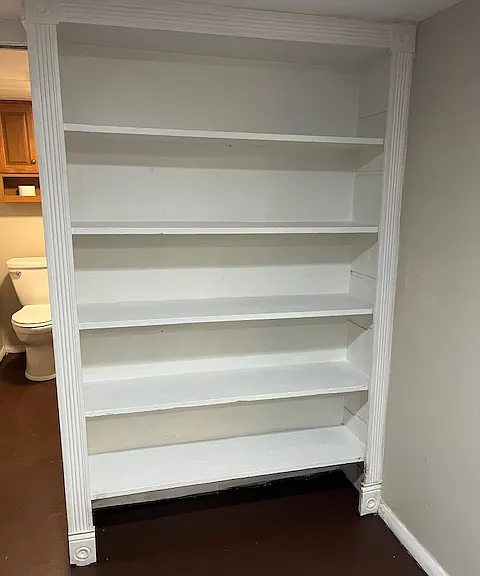 Built-in bookshelf in common area of unit.