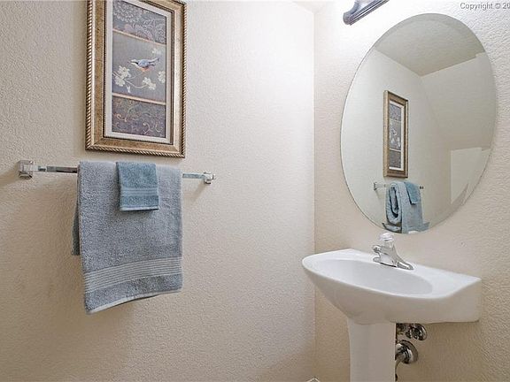 There is also a Powder Bathroom off the hallway with a pedestal sink
