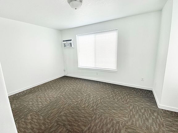 Bedroom - comes with in-wall AC unit left of window. Also has electric wall cadet heater.