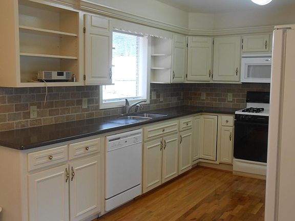 Kitchen with corian countertops, double oven, cabinets with