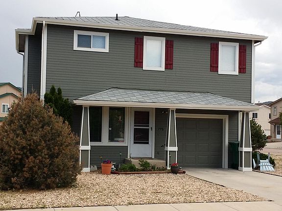 Each side of the duplex has its own private entrance, a single car garage and a small flower bed.