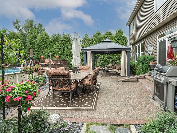 The 20 x 30 brick paver patio is edged and has a herringbone pattern in the center.