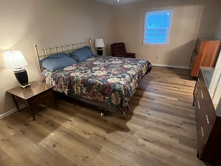 This is the master bedroom. it is furnished with a king bed, a luxury, high boy and low boy dresser with glass tops in mint condition and two side tables. it has a brand new tile shower, huge walk-in closet, a second closet in the bedroom, dual vanity