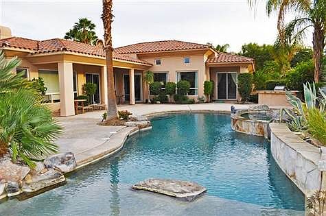 Pool features a tanning ledge area.