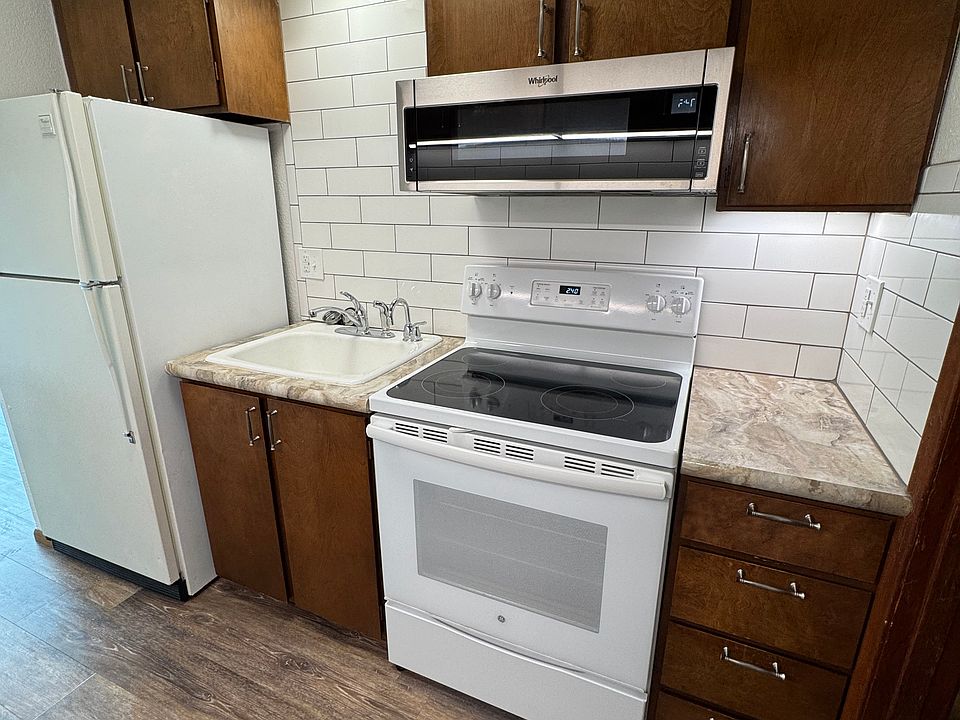 Kitchen with brand new microwave and tile backsplash. New vinyl plank flooring throughout. Unit comes with an Instahot water dispenser, new faucet and garbage disposal.