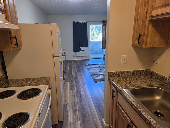 Kitchen with view of living room and front patio
