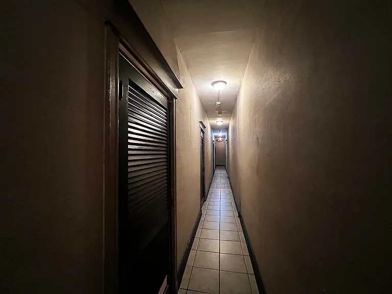 Looking the other way from apartment down hallway.