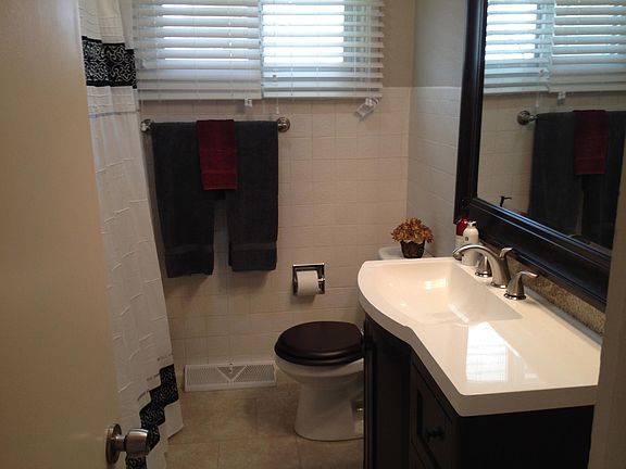 Main bath with rain showerhead and large linen closet