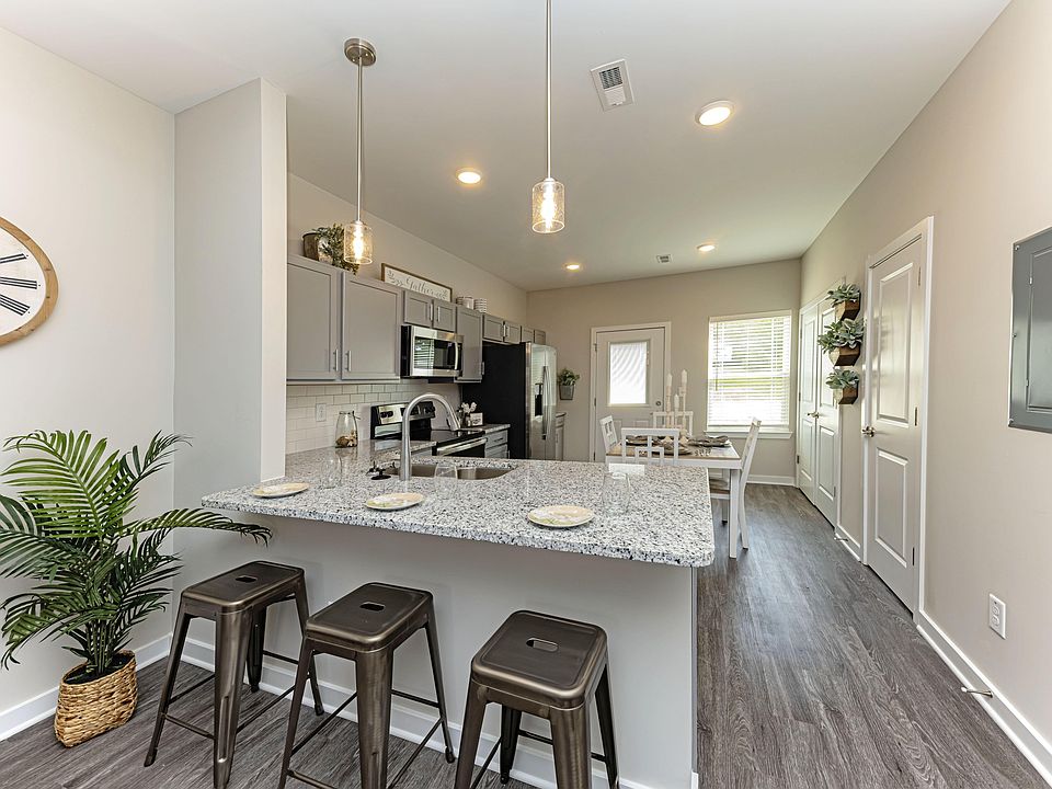 Kitchen with granite counters, stainless appliances, and modern cabinetry