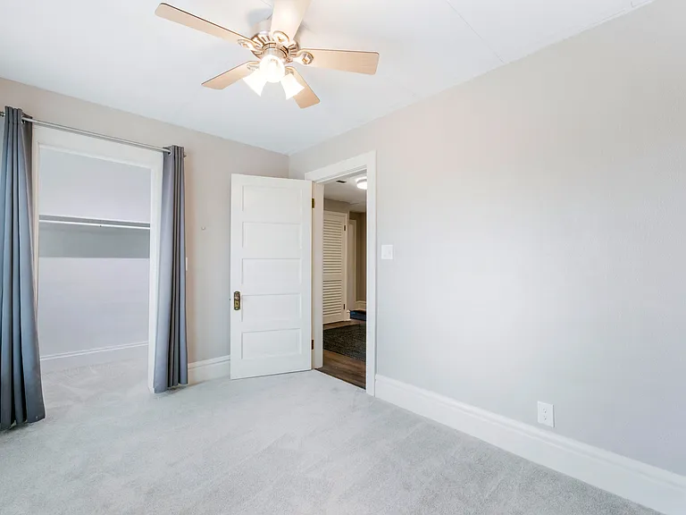 first bedroom with walk in closet