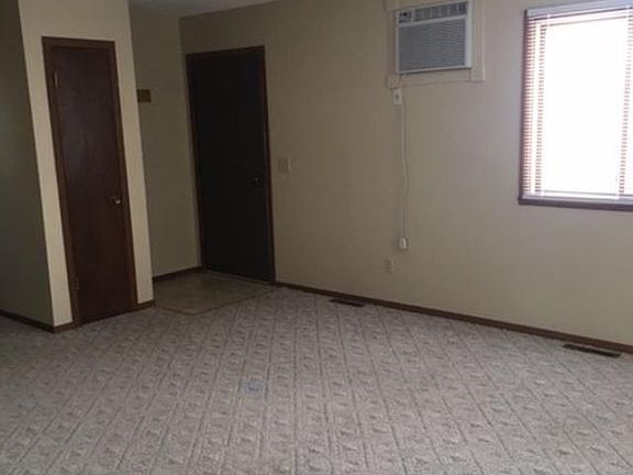 Front door and entry closet. Hallway to left. Kitchen and di