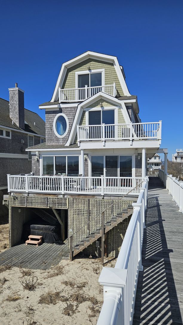  Rear view of house with hot tub and outdoor shower on ground level