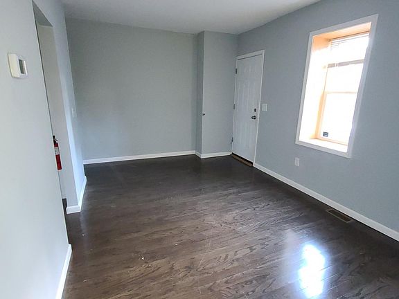 Spacious living room with hardwood floors, central air conditioning