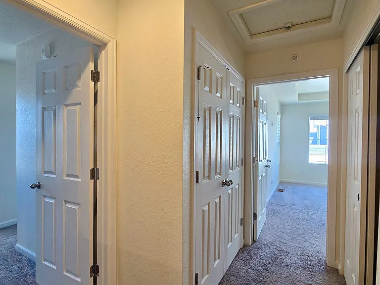 Upstairs hallway leading to bedrooms with en suite bathrooms.