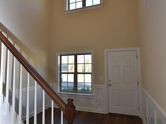 Two story foyer with wainscoting