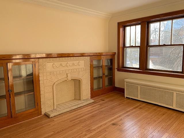 Living room with built-in bookshelves, fireplace facade.