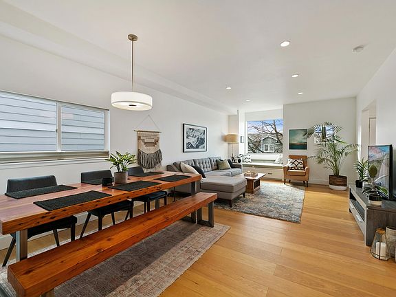 Large open living and dining room on main floor with window seat and lots of natural light