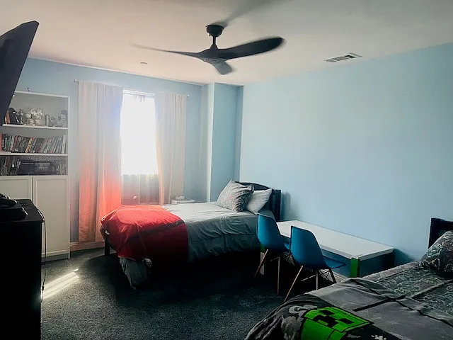 Bedroom #2: Twin beds, Ceiling fan, Flat screen TV w/ Fire-stick, Dresser, Table w/ 2 chairs, Bookshelf, Spacious closet, Black-out curtains.