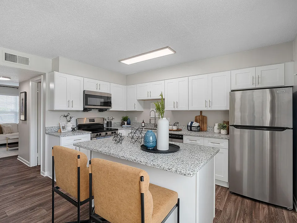 Kitchen with granite counters, stainless appliances, and modern cabinetry