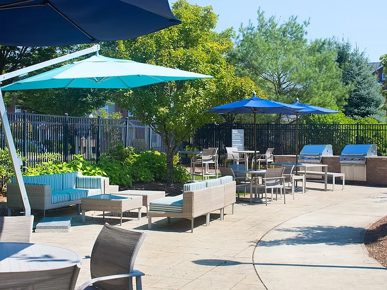 Outdoor courtyard with lounge seating and barbecue grills