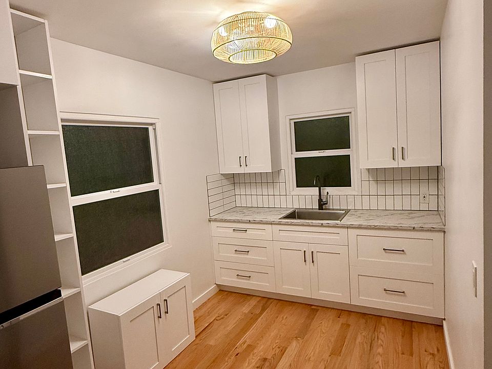 Newly renovated kitchen with hardwood floors and custom cabinets.