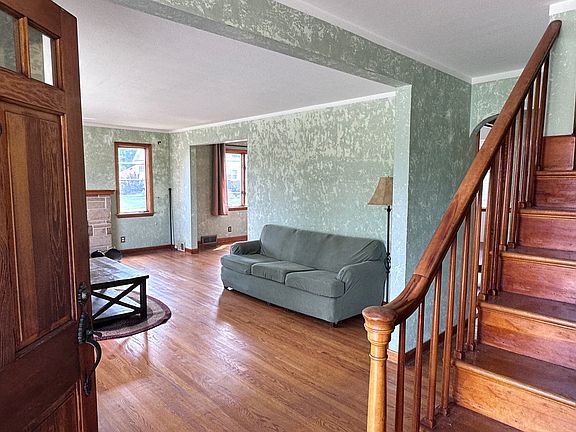 Entryway opens to stairs and the living room on your left, along with a wraparound hallway to the kitchen and remainder of the main level.