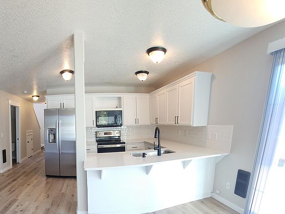 Kitchen with quartz counters and all new appliances.
