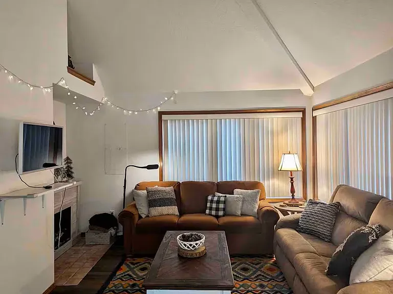 Living room with wall-mounted smart TV / Roku device