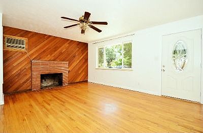 Living room offers hardwood floors & wood burning fireplace
