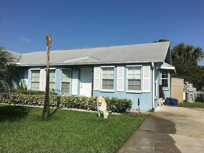 Front of unit with private entrance and driveway