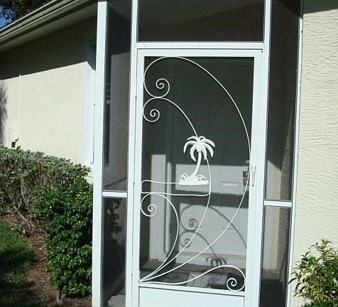 Side entry with screened enclosure, paver walk way to front door.