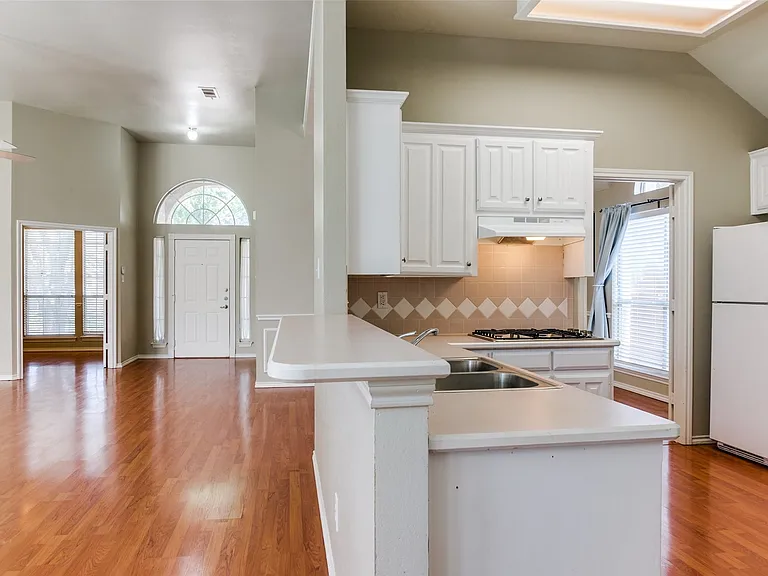 Open concept floor plan with breakfast bar.