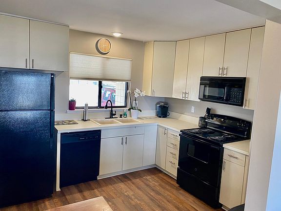 New appliances and hardwood floors in well-lit kitchen.