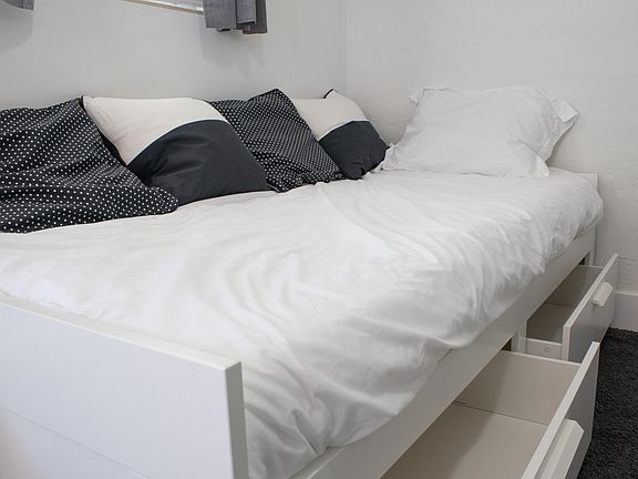The bed can be a twin bed but is also customizable to create more space. Added storage under the bed in big drawers.
