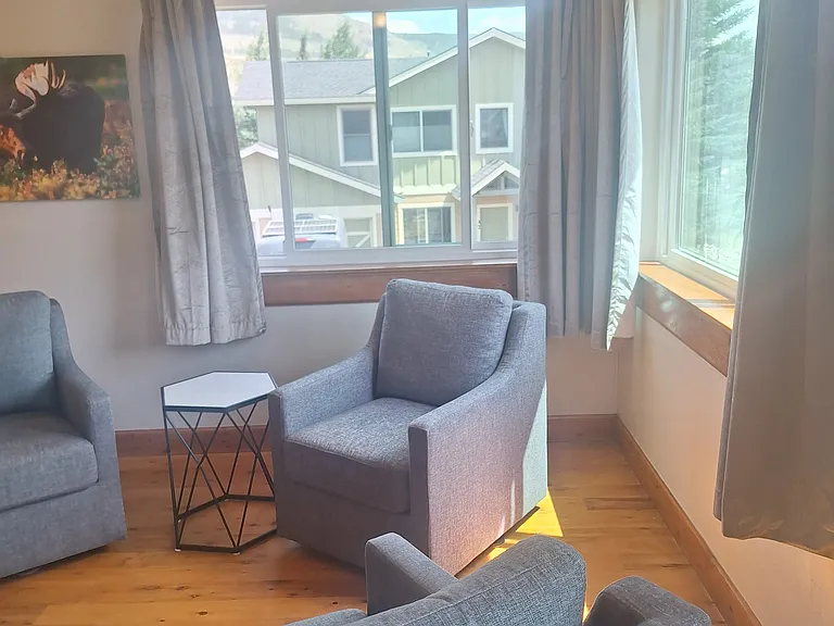 Living room with large eastern and southern facing windows.