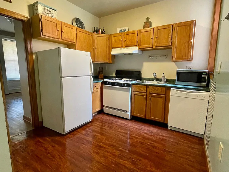 Kitchen with full gas oven, dishwasher and microwave.