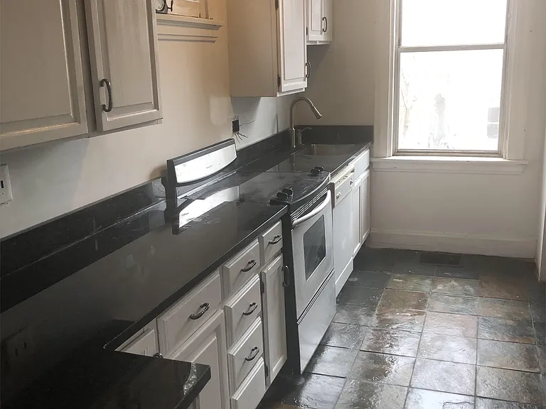Kitchen with black granite countertops and dishwasher