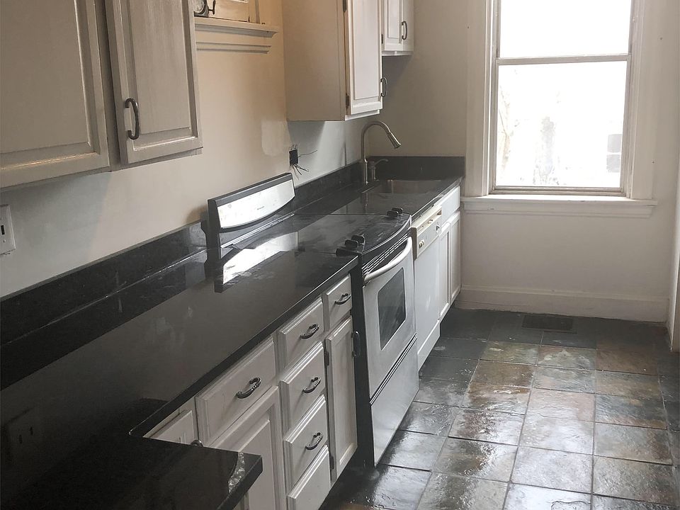 Kitchen with black granite countertops and dishwasher