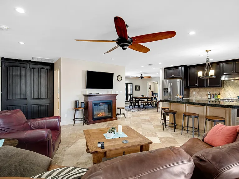 Living area with electric fireplace and flatscreen. Washer and dryer are behind the barn doors on the left.