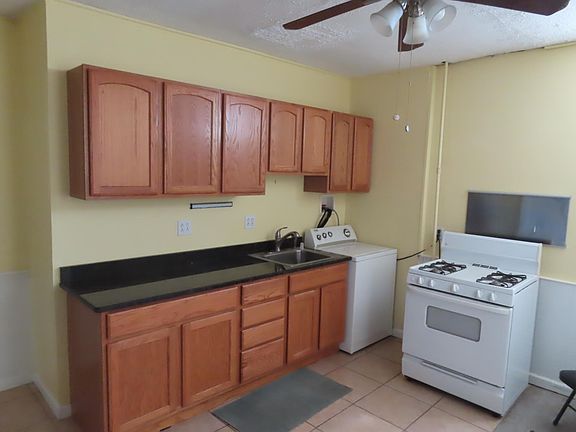 Large kitchen with new granite counter tops, washer and gas stove and cabinets