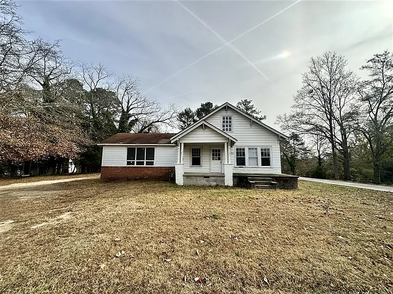 Front of house - Paved driveway to the right. Parking in back of house.
