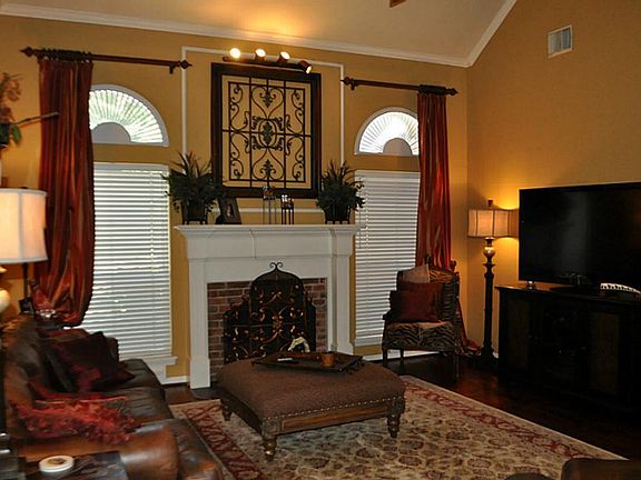 Lving room view with hardwood flooring and fireplace.