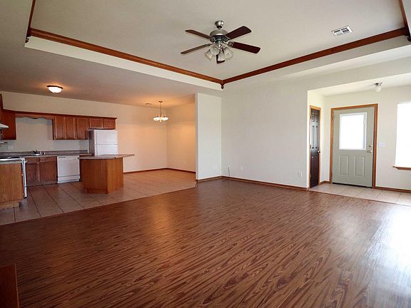Kitchen, dining, and living room areas with gas log fireplac