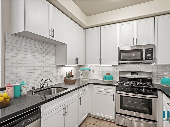 Kitchen with Stainless-Steel Dishwasher, Stove, and Microwave Oven