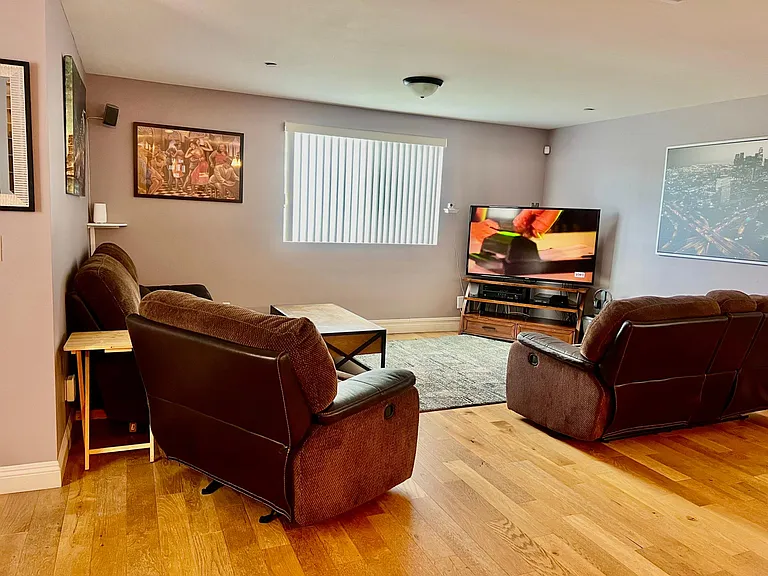 Living Room has Ceiling fan, Reclining couches, Flat screen TV w/ Fire-stick and two work spaces w/ Hi-speed WiFi.
